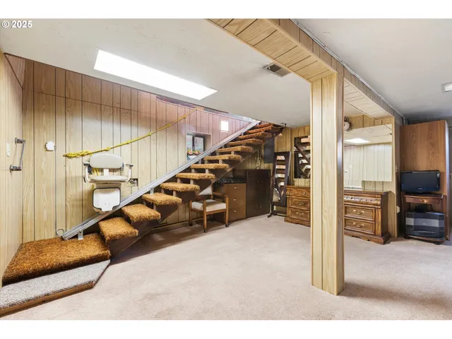 a view of a livingroom with furniture and stairs