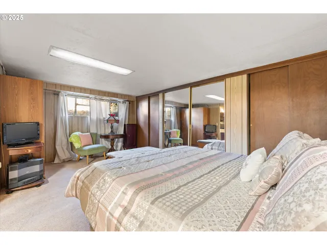 a bedroom with a bed window and a couch