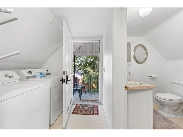a bathroom with a sink vanity mirror and toilet