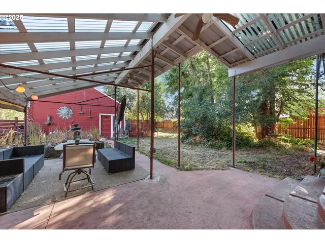 a view of patio with a table and chairs