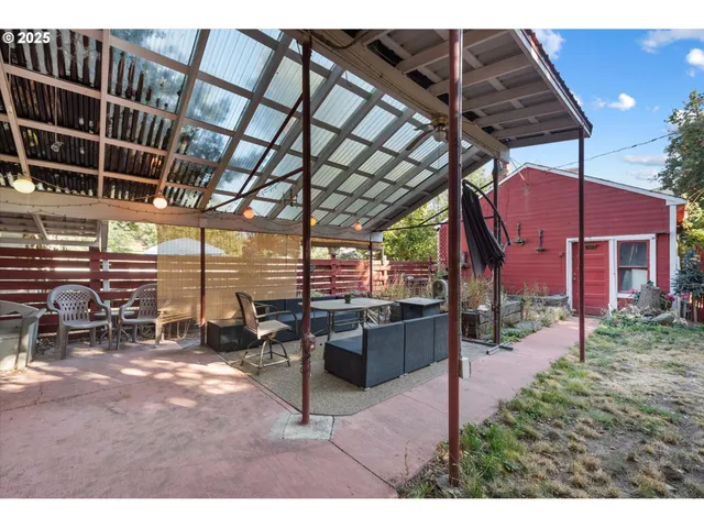 a view of a backyard with sitting area