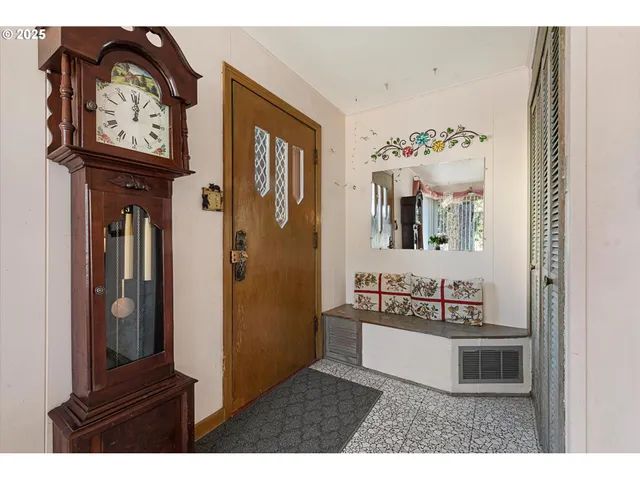 a living room with furniture and a mirror