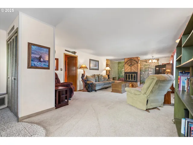 a living room with furniture and a bookshelf