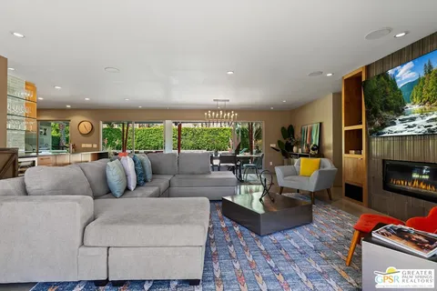 a living room with fireplace furniture and a flat screen tv