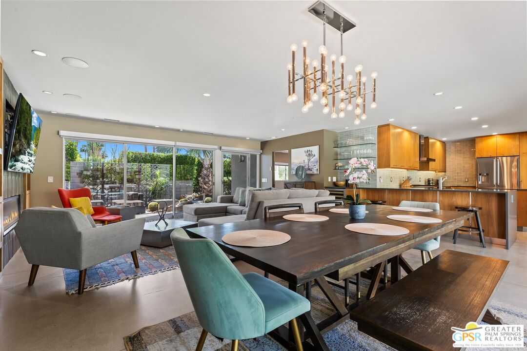 1349 Sagebrush Road Palm Springs, CA 92264 - Photo 17 of 61 a view of a dining room with furniture a chandelier and wooden floor