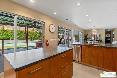 a kitchen with stainless steel appliances granite countertop sink stove and cabinets