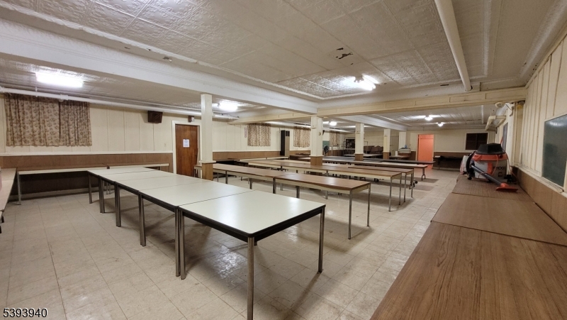 221 Spring Street Paterson, NJ 07503 - Photo 12 of 30 a kitchen with stainless steel appliances kitchen island granite countertop lots of counter top space and furniture