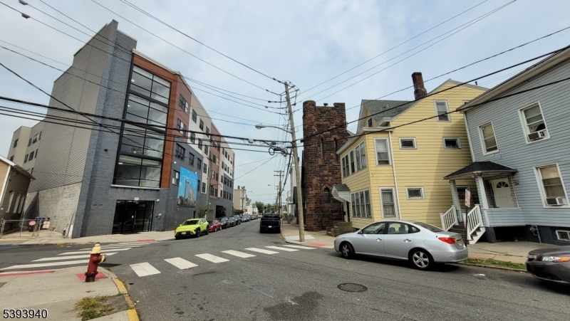 221 Spring Street Paterson, NJ 07503 - Photo 16 of 30 a couple of cars parked in front of a building