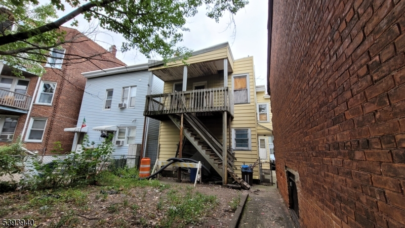 221 Spring Street Paterson, NJ 07503 - Photo 18 of 30 a view of a house with a yard