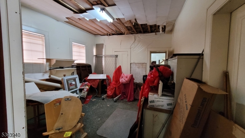 221 Spring Street Paterson, NJ 07503 - Photo 21 of 30 a living room with furniture and a flat screen tv