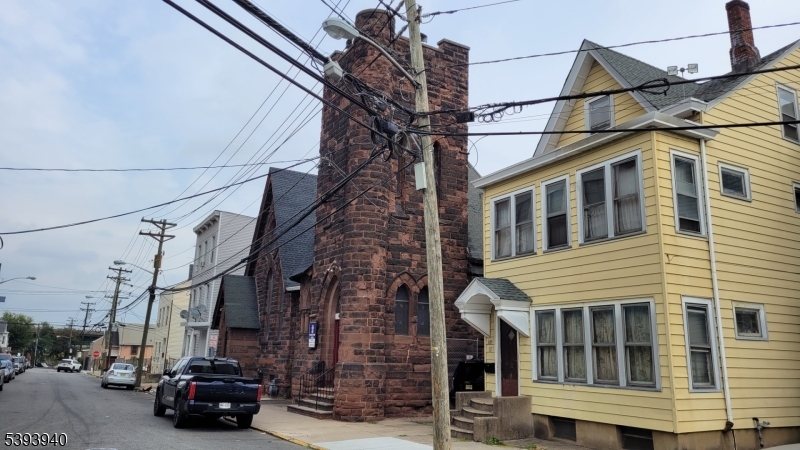 221 Spring Street Paterson, NJ 07503 - Photo 28 of 30 a car parked in front of a building