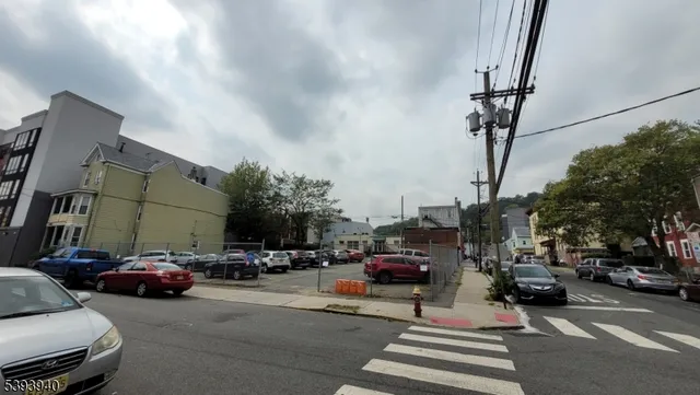a view of a cars parked on the side of a street