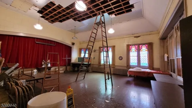 a living room with furniture a window and a chandelier