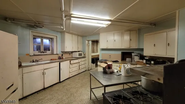 a living room with furniture a fireplace and a chandelier