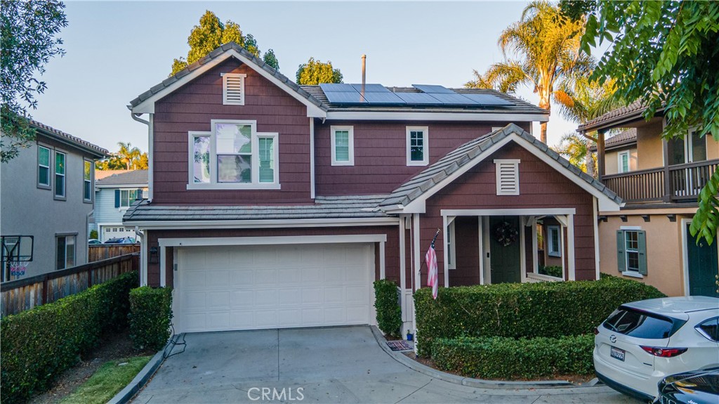 a front view of a house with a garden and plants