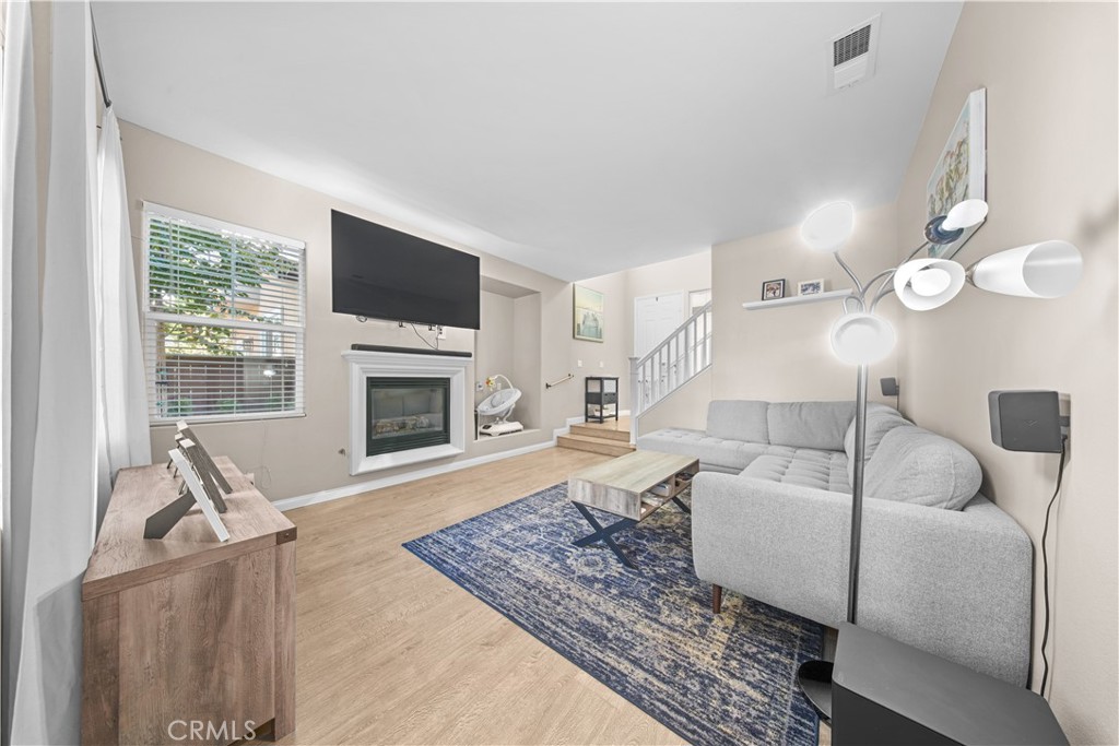4 Potters Bend Ladera Ranch, CA 92694 - Photo 11 of 31 a living room with furniture a flat screen tv and a fireplace