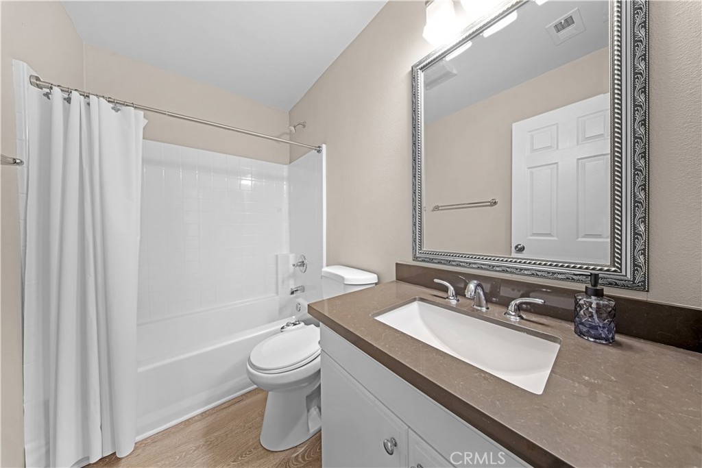 4 Potters Bend Ladera Ranch, CA 92694 - Photo 15 of 31 a bathroom with a granite countertop sink toilet a mirror and shower