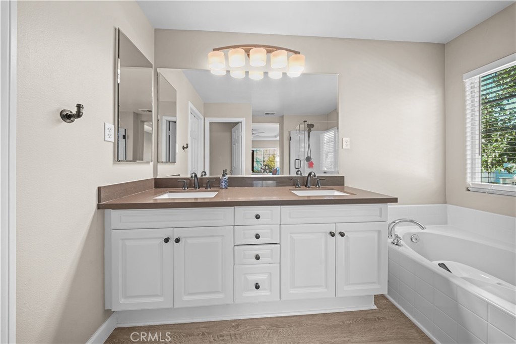 4 Potters Bend Ladera Ranch, CA 92694 - Photo 20 of 31 a spacious bathroom with a granite countertop sink a large mirror a shower and a bathtub