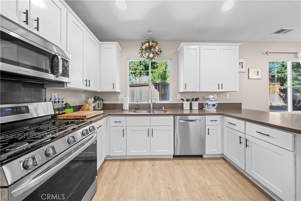 4 Potters Bend Ladera Ranch, CA 92694 - Photo 2 of 31 a kitchen with stainless steel appliances a white stove top oven and sink