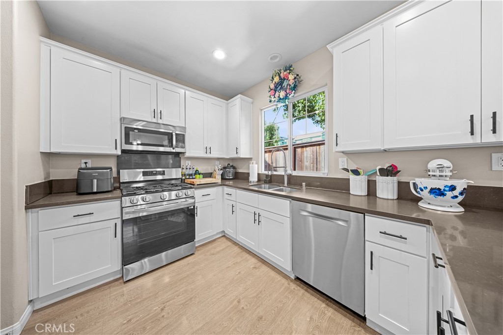 4 Potters Bend Ladera Ranch, CA 92694 - Photo 3 of 31 a kitchen with cabinets appliances a sink and a window