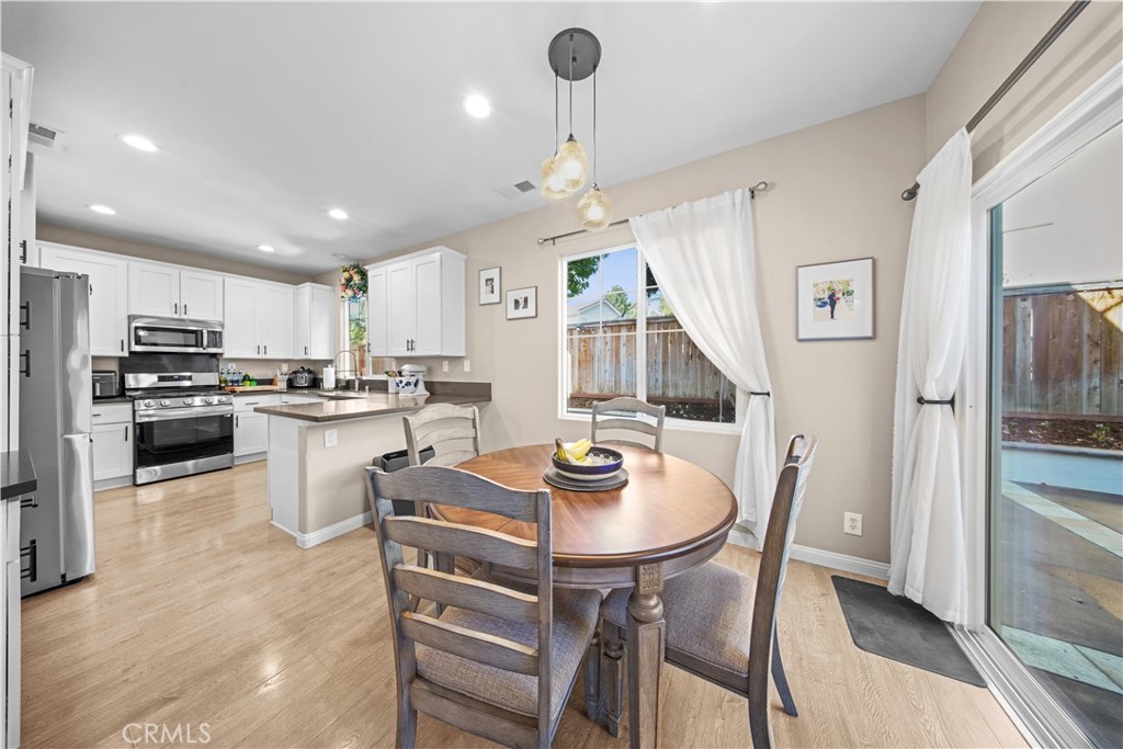 4 Potters Bend Ladera Ranch, CA 92694 - Photo 6 of 31 a kitchen with stainless steel appliances granite countertop a stove a refrigerator a kitchen island a dining table and chairs