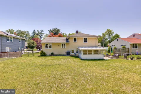 a view of a house with swimming pool and a yard