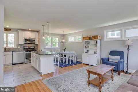 a living room with furniture and a kitchen view