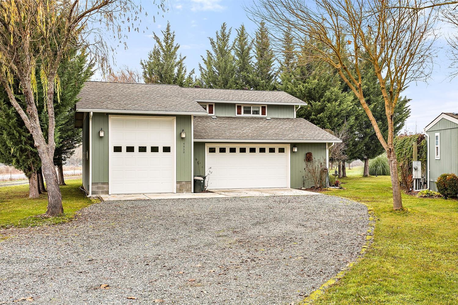 4930 Leonard Road Grants Pass, OR 97527 - Photo 2 of 33 a front view of a house with a yard and garage