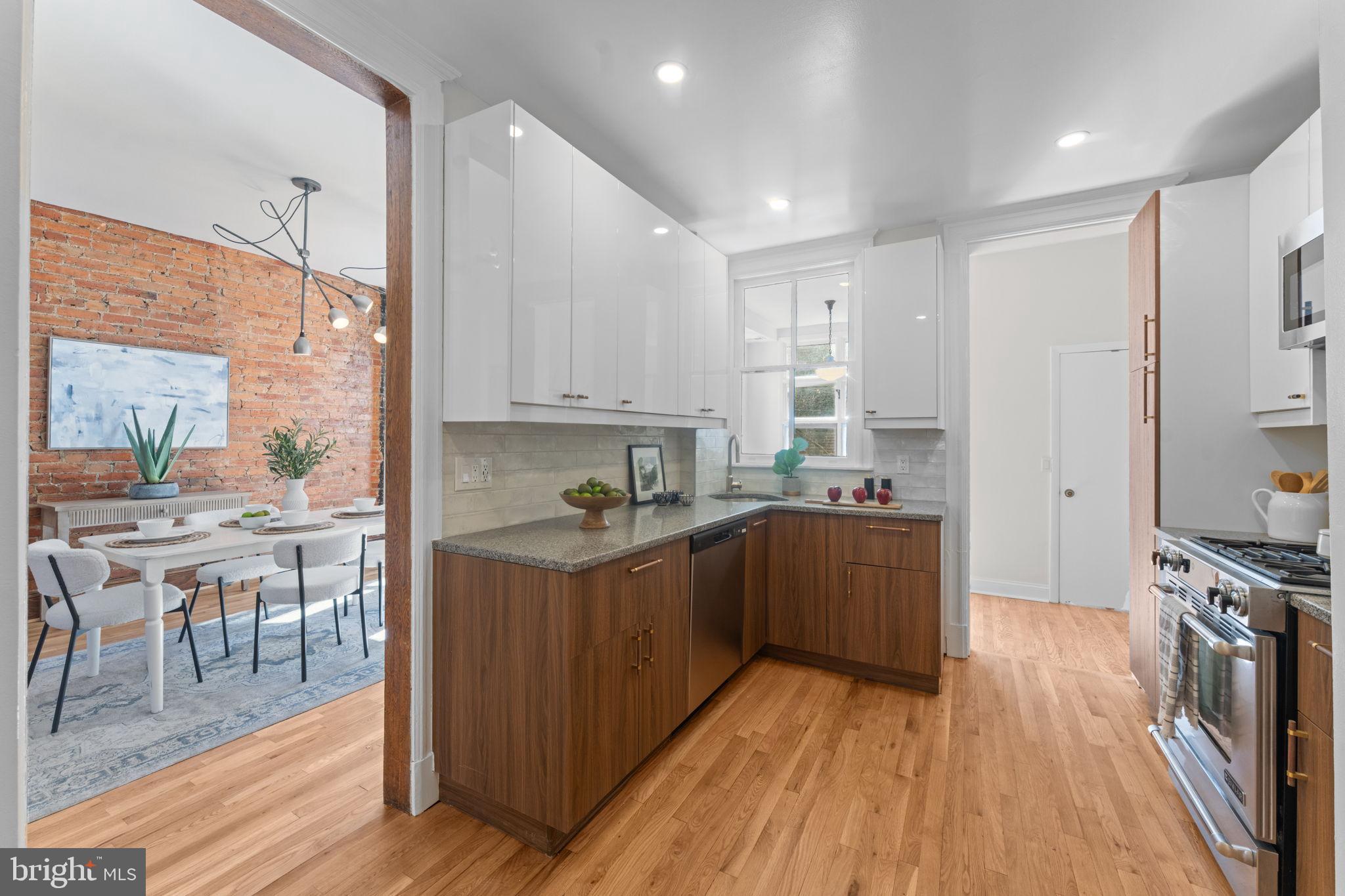 1802 Lamont Street Northwest Washington, DC 20010 - Photo 29 of 118 a kitchen with stainless steel appliances granite countertop a stove top oven a sink dishwasher and a refrigerator with wooden floor