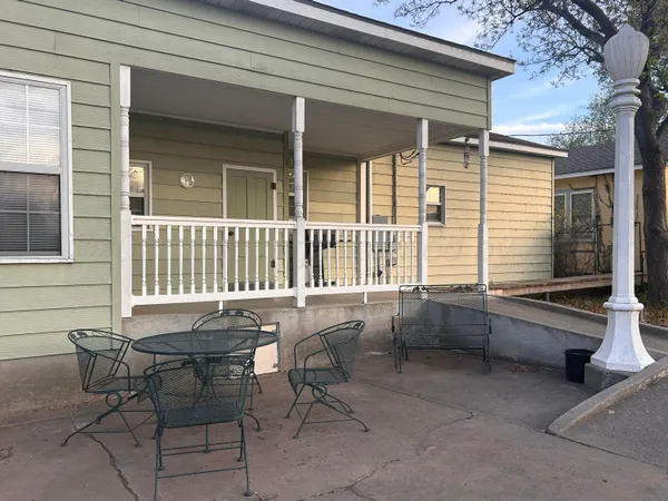 a backyard of a house with outdoor seating