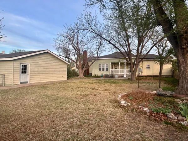 a house that has a tree in front of it