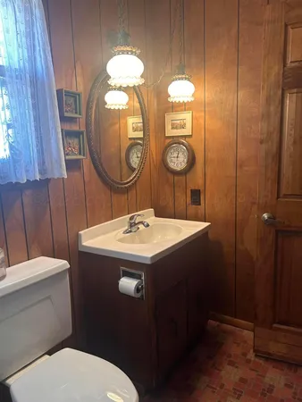 a bathroom with a toilet sink and mirror