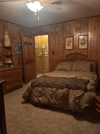 a bedroom with a bed and a mirror