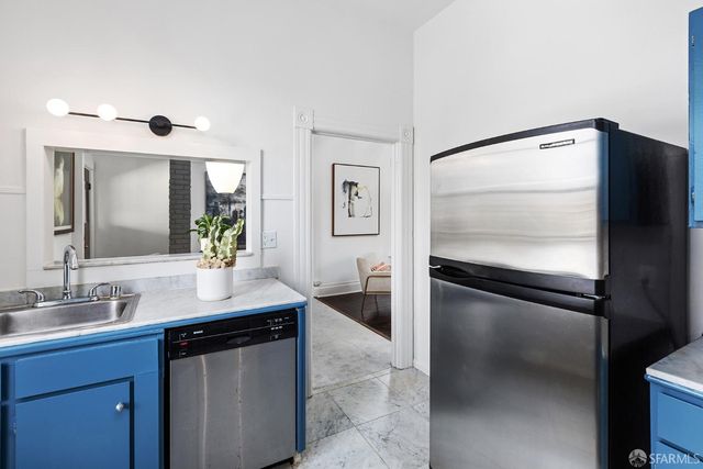 a kitchen with a refrigerator and a sink