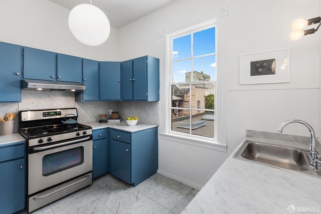 a kitchen with granite countertop a stove and a sink