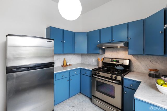 a kitchen with a stove and a refrigerator