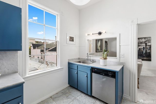 a en suite bathroom with a granite countertop sink and a mirror