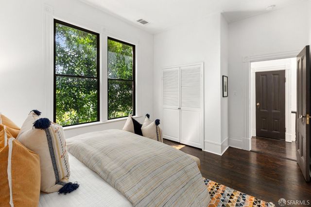 a bedroom with a bed and a large window