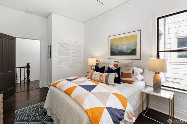 a bedroom with bed and a window