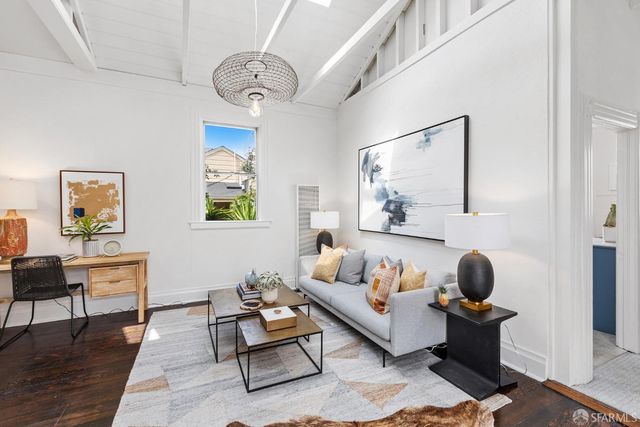 a living room with furniture rug and window