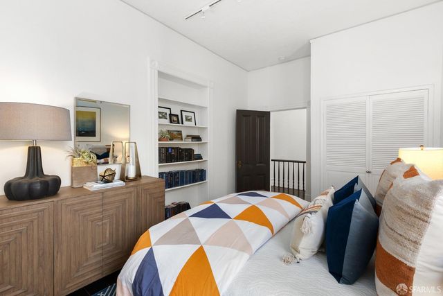 a bedroom with a bed and dresser