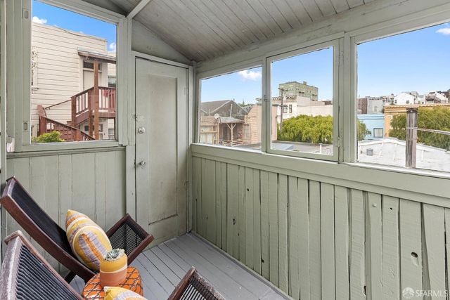 a view of a balcony with chair and front door