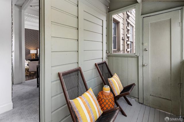 a view of a hallway with furniture and windows