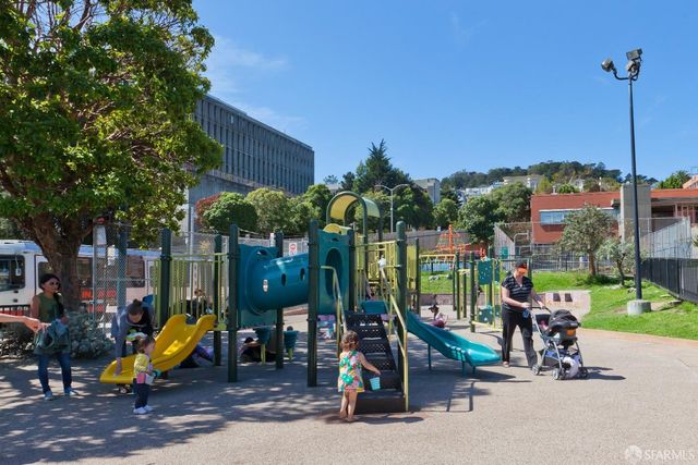 a view of a park with large trees