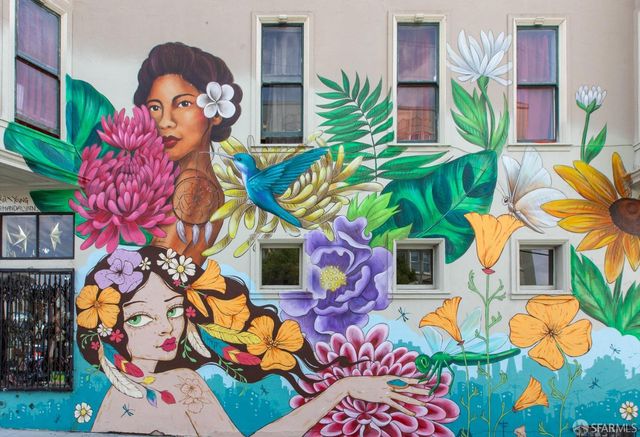 a view of a house with a yard and potted plants