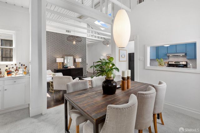 a dining room with furniture and wooden floor