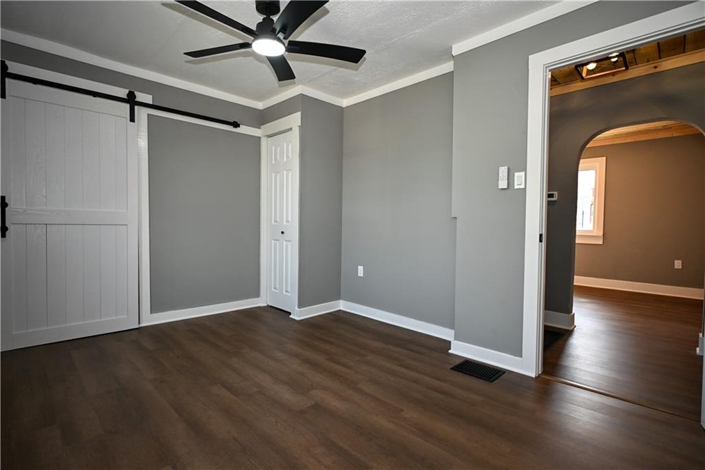 485 Wendel Road Irwin, PA 15642 - Photo 17 of 30 an empty room with wooden floor cabinet and windows