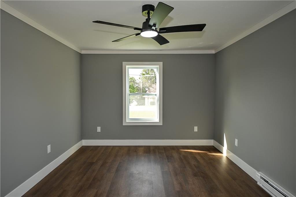 485 Wendel Road Irwin, PA 15642 - Photo 20 of 30 a view of an empty room with wooden floor and a window