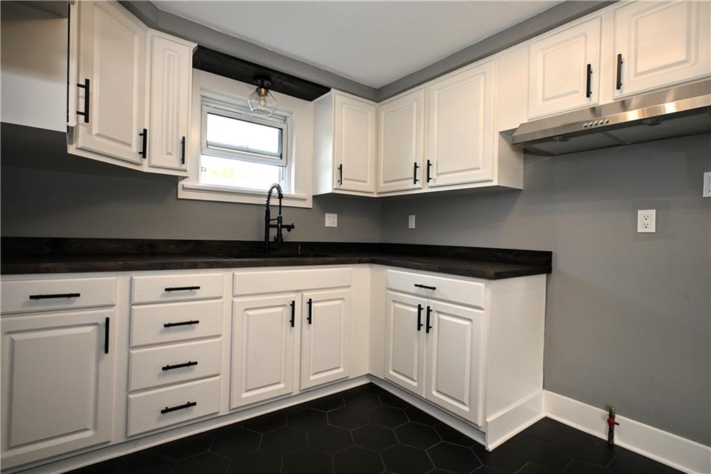 485 Wendel Road Irwin, PA 15642 - Photo 8 of 30 a kitchen with granite countertop white cabinets and white appliances