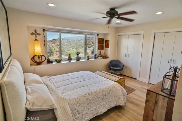 a bedroom with a bed a couch and a painting on the wall